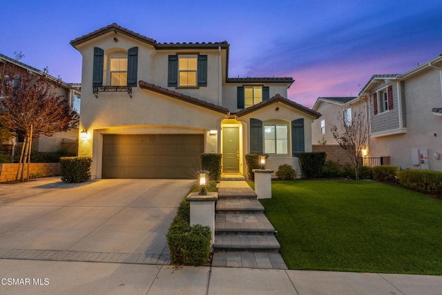 mediterranean / spanish-style house with a lawn and a garage