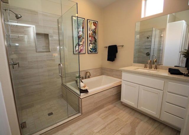 bathroom with vanity and shower with separate bathtub