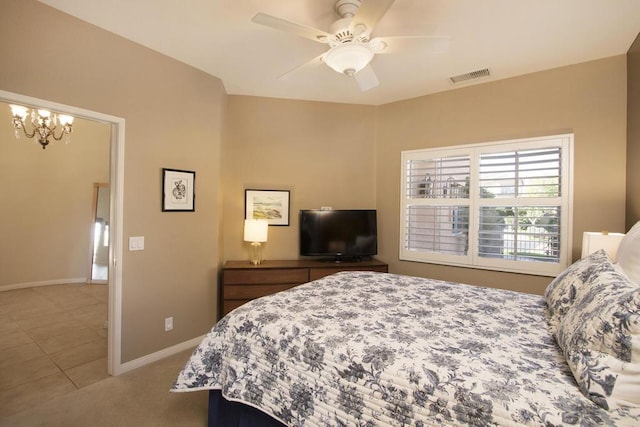 bedroom with tile patterned flooring and ceiling fan with notable chandelier