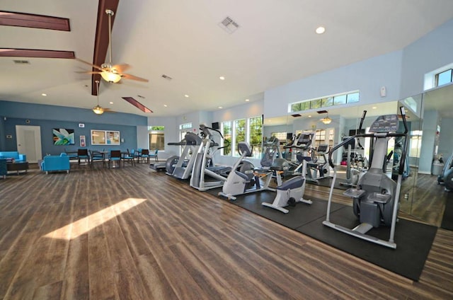 gym with ceiling fan and a towering ceiling