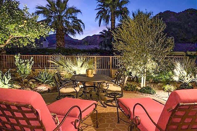 patio terrace at dusk featuring an outdoor hangout area and a mountain view