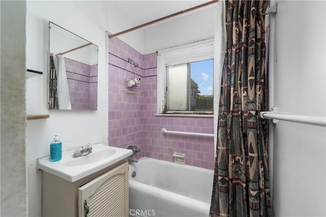 bathroom featuring shower / bath combo with shower curtain and vanity