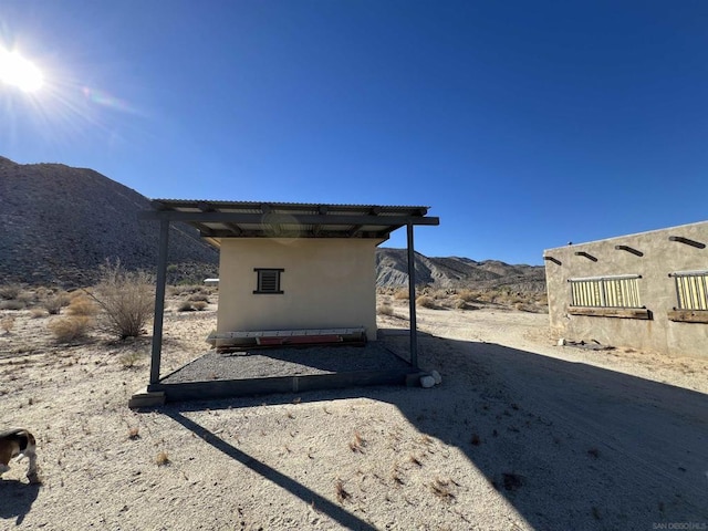 view of side of home with a mountain view