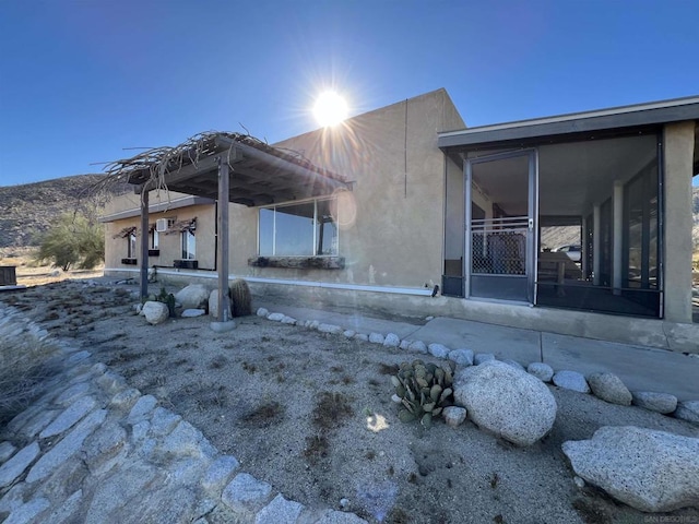 back of house with a sunroom