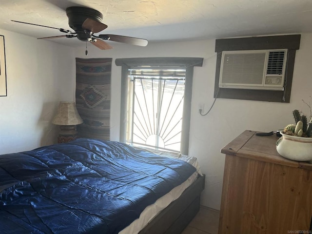 bedroom featuring an AC wall unit and ceiling fan