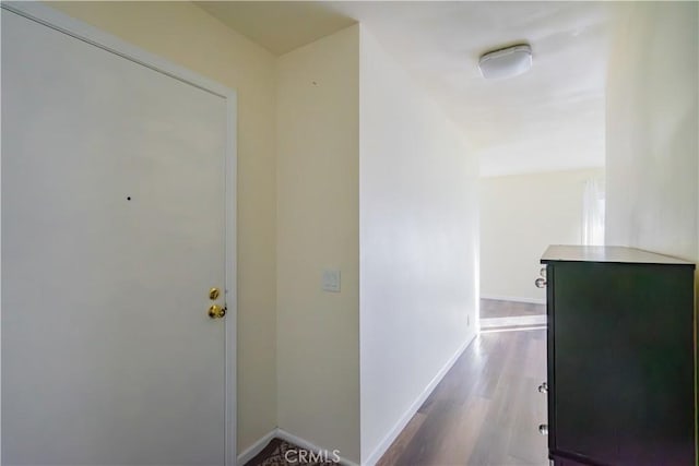 hallway with hardwood / wood-style floors