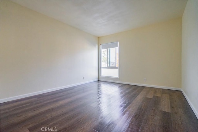 spare room with dark hardwood / wood-style floors