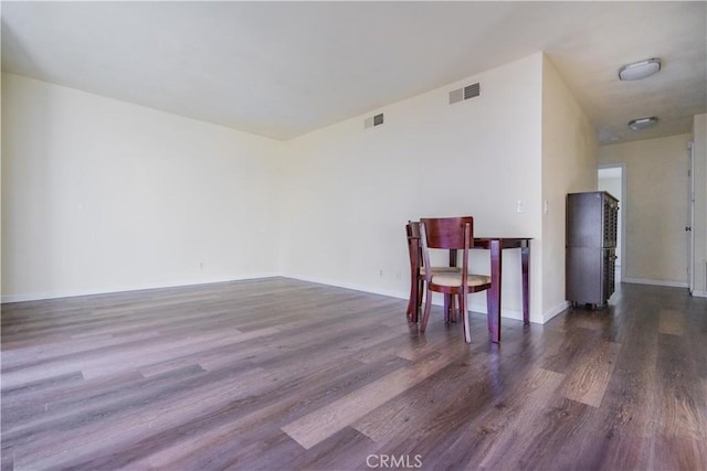 unfurnished room with dark hardwood / wood-style flooring