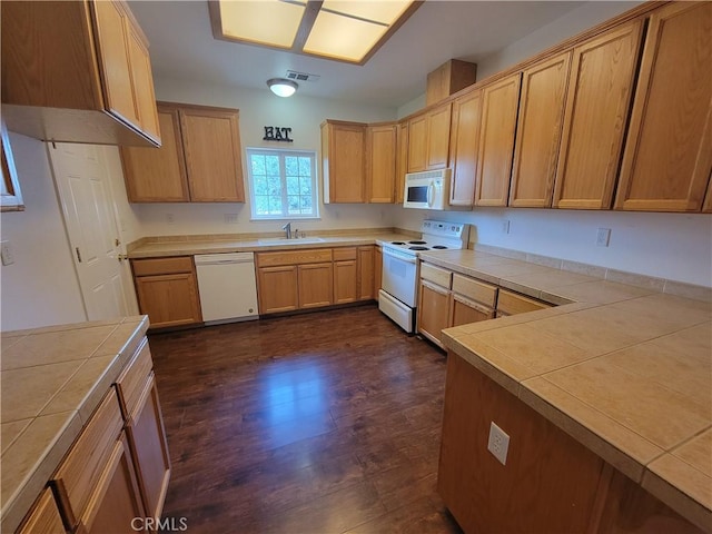 kitchen with tile countertops, white appliances, sink, and dark wood-type flooring