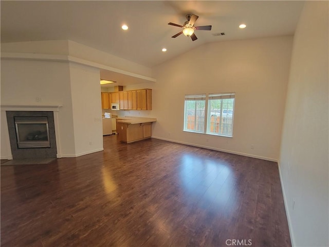 unfurnished living room featuring ceiling fan, dark wood-type flooring, and vaulted ceiling