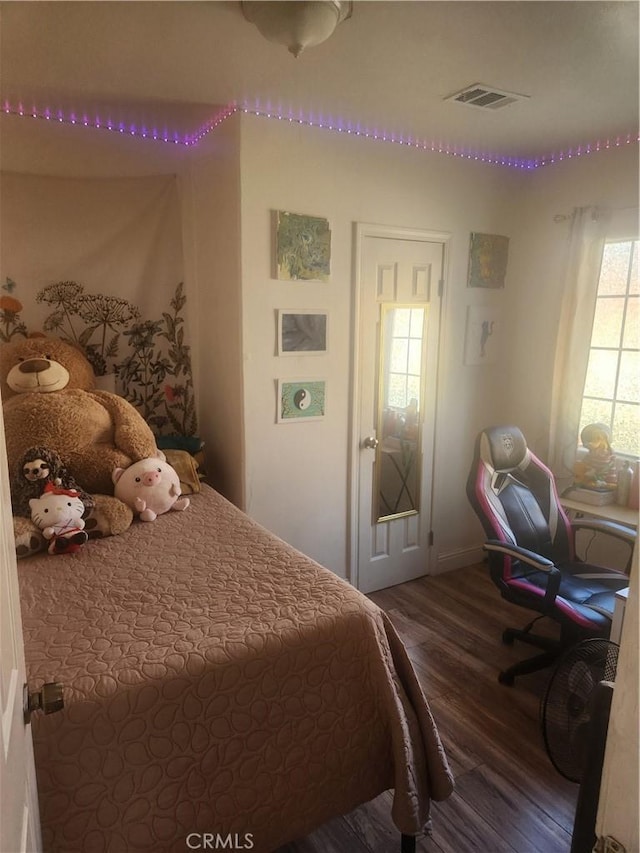 bedroom with dark hardwood / wood-style flooring