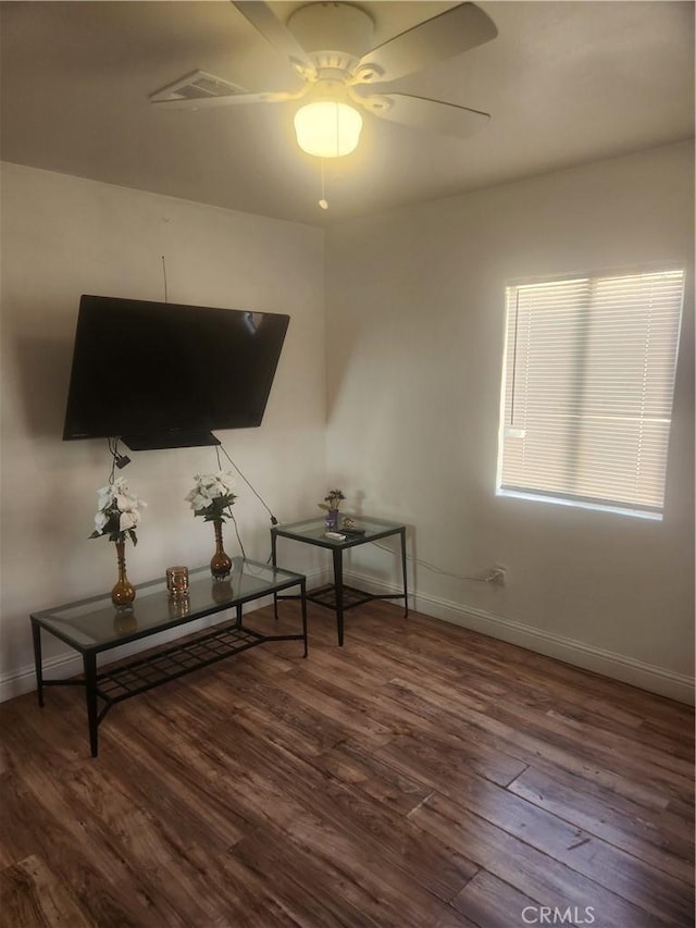 interior space featuring dark wood-type flooring and ceiling fan