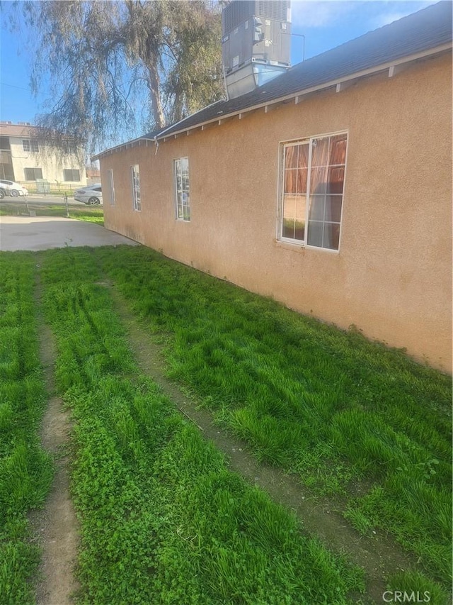 view of side of home featuring a lawn