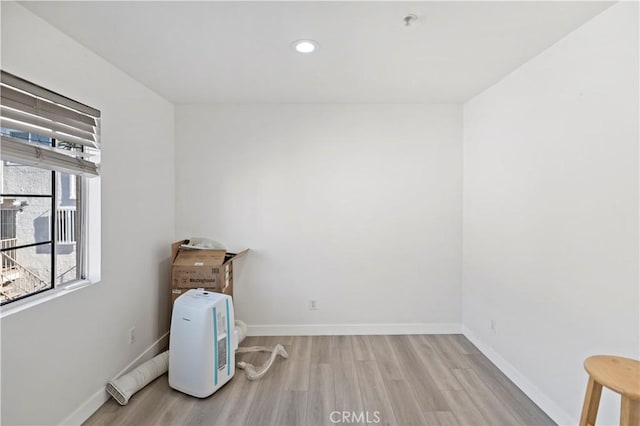 empty room with light hardwood / wood-style flooring