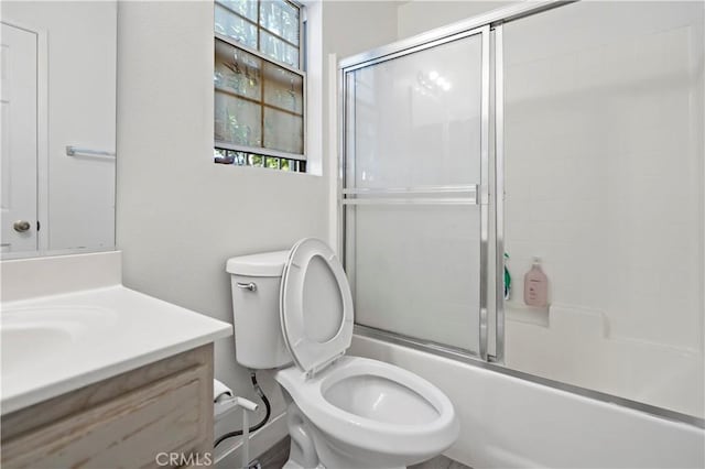 full bathroom with shower / bath combination with glass door, vanity, and toilet