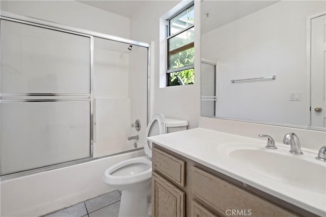 full bathroom with tile patterned floors, vanity, enclosed tub / shower combo, and toilet