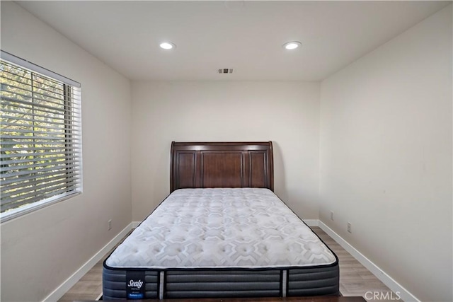 bedroom with hardwood / wood-style floors