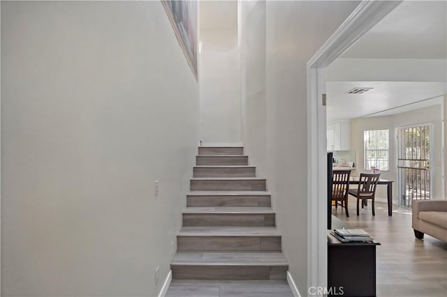 stairway with hardwood / wood-style floors