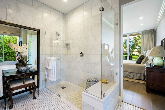 bathroom featuring a tile shower and ornamental molding