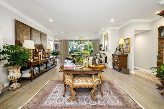 dining room with light wood-type flooring and ornamental molding