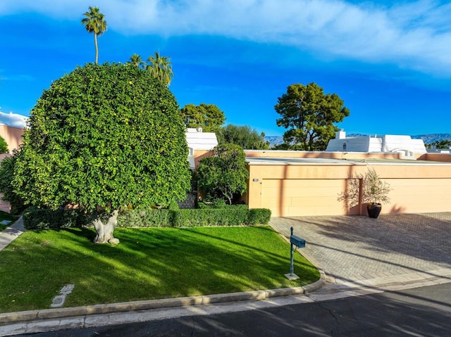 view of front facade with a front yard and a garage