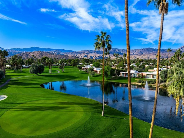 surrounding community with a water and mountain view