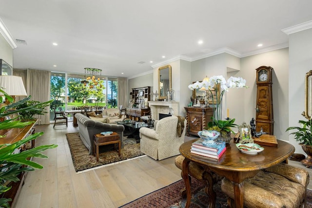 living room with crown molding and light hardwood / wood-style flooring