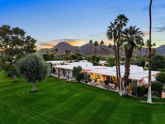 exterior space featuring a mountain view and a yard