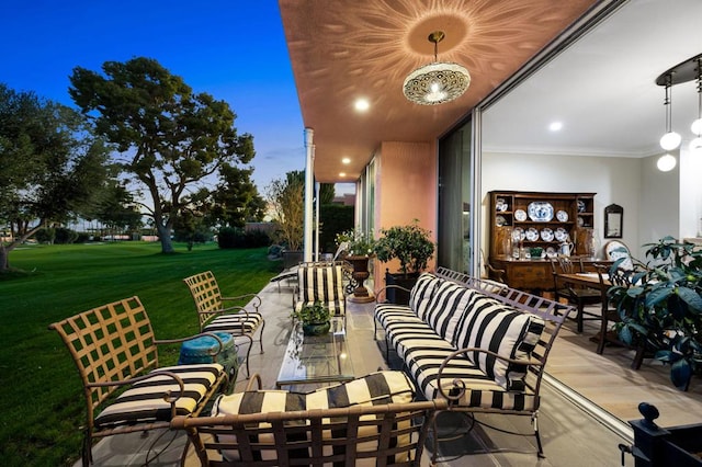 patio terrace at dusk with a lawn and outdoor lounge area