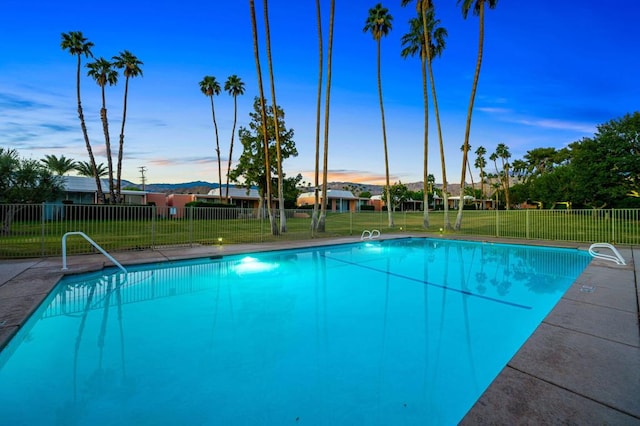 view of pool with a lawn