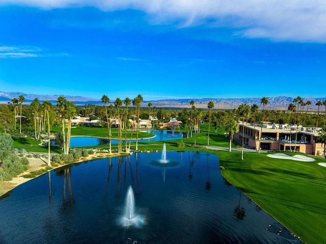 surrounding community with a yard and a water and mountain view