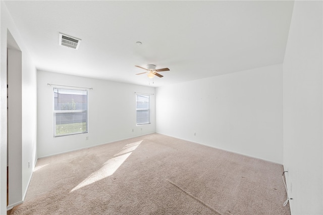 carpeted empty room featuring ceiling fan