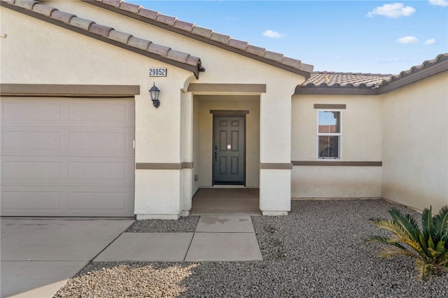 view of exterior entry featuring a garage