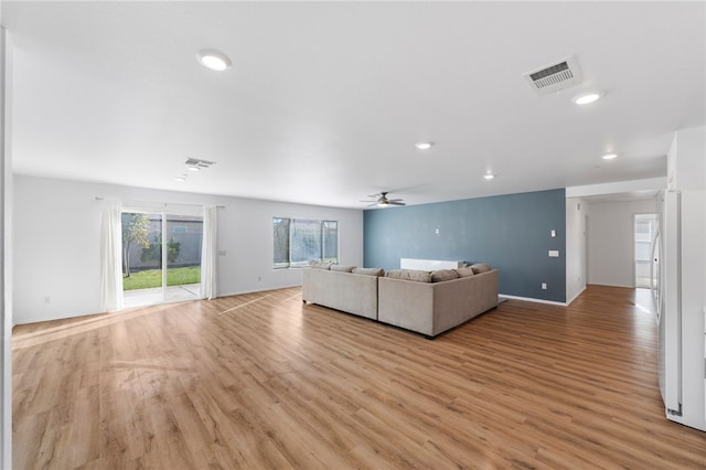 unfurnished living room with ceiling fan and light hardwood / wood-style flooring