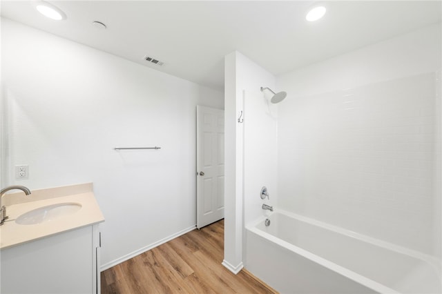 bathroom featuring vanity, shower / bathtub combination, and hardwood / wood-style flooring