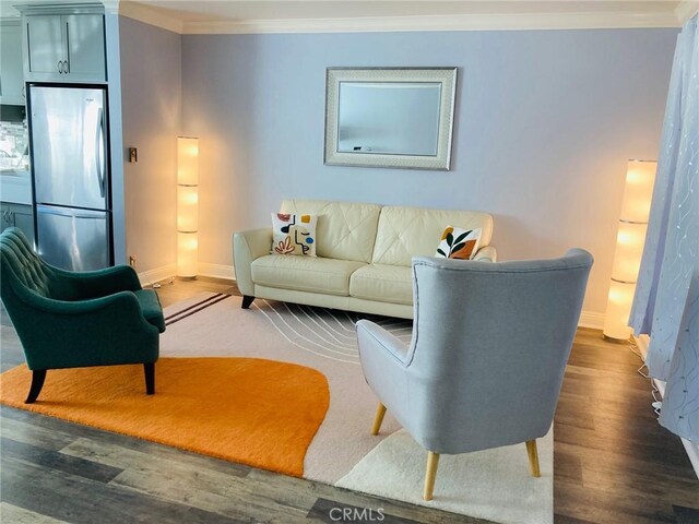 living room featuring crown molding and dark hardwood / wood-style flooring