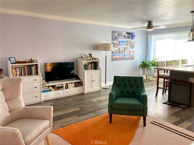 living room with ceiling fan, ornamental molding, and dark wood-type flooring