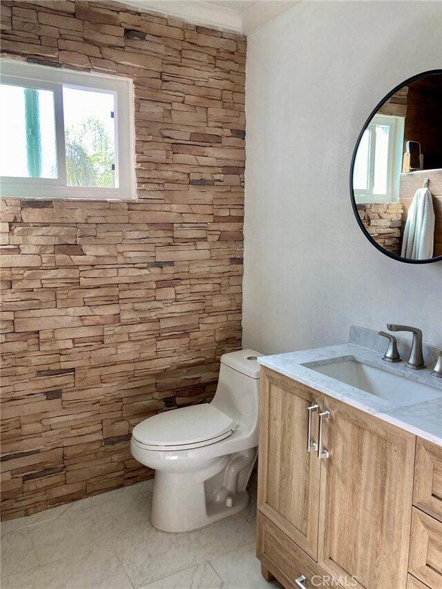 bathroom with vanity, a healthy amount of sunlight, and toilet