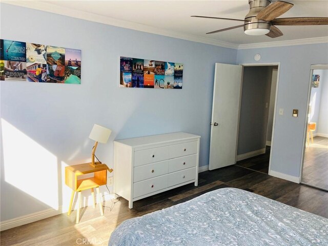 bedroom with ceiling fan, dark hardwood / wood-style flooring, and crown molding