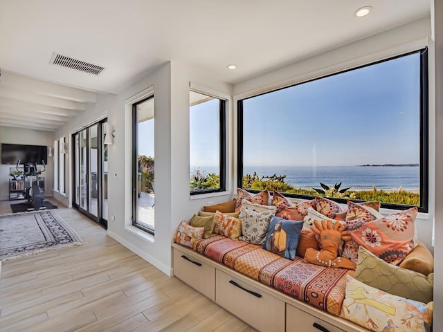 interior space featuring a water view and light hardwood / wood-style floors