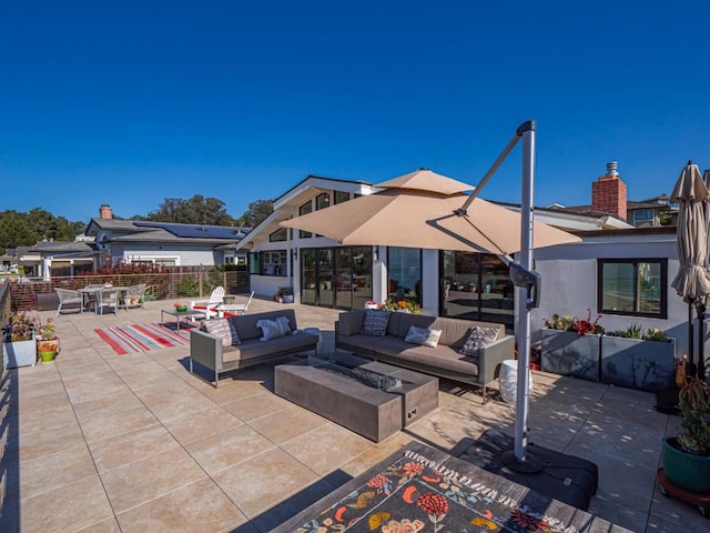 view of patio / terrace featuring an outdoor living space with a fire pit