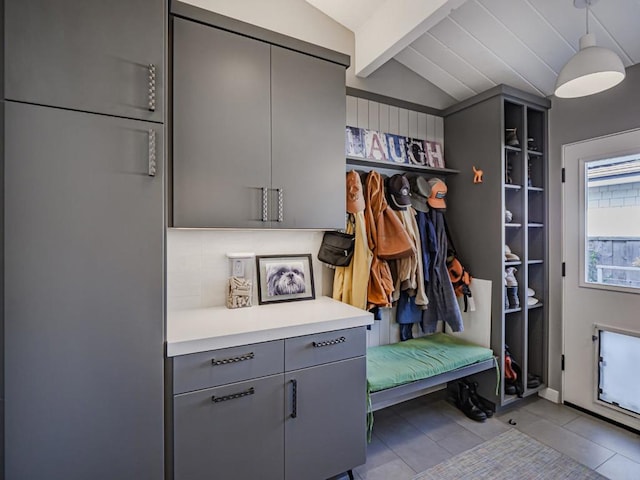 mudroom featuring lofted ceiling with beams and light tile patterned flooring