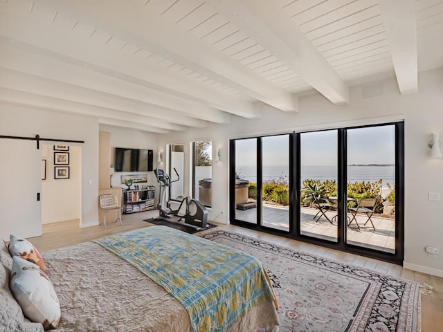 bedroom featuring a barn door, beam ceiling, access to exterior, and light hardwood / wood-style flooring