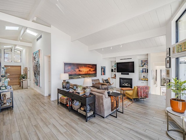 living room with beam ceiling, high vaulted ceiling, and light wood-type flooring