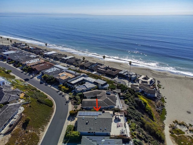 drone / aerial view featuring a water view and a beach view