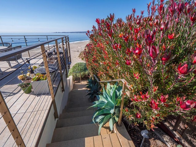 balcony with a beach view and a water view