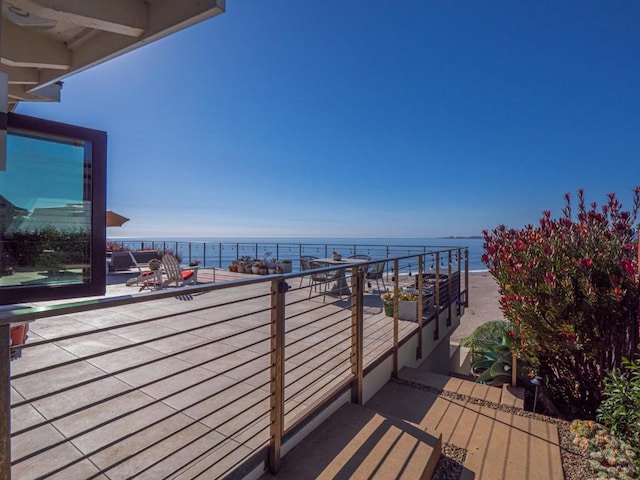 view of dock featuring a balcony and a water view