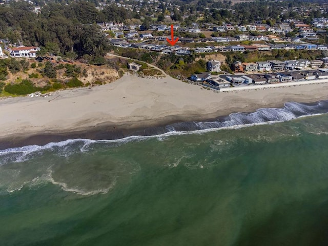 bird's eye view featuring a water view and a view of the beach