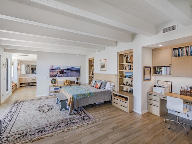 bedroom with beam ceiling and light wood-type flooring