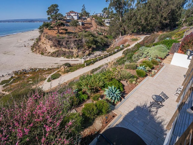 aerial view with a water view and a view of the beach